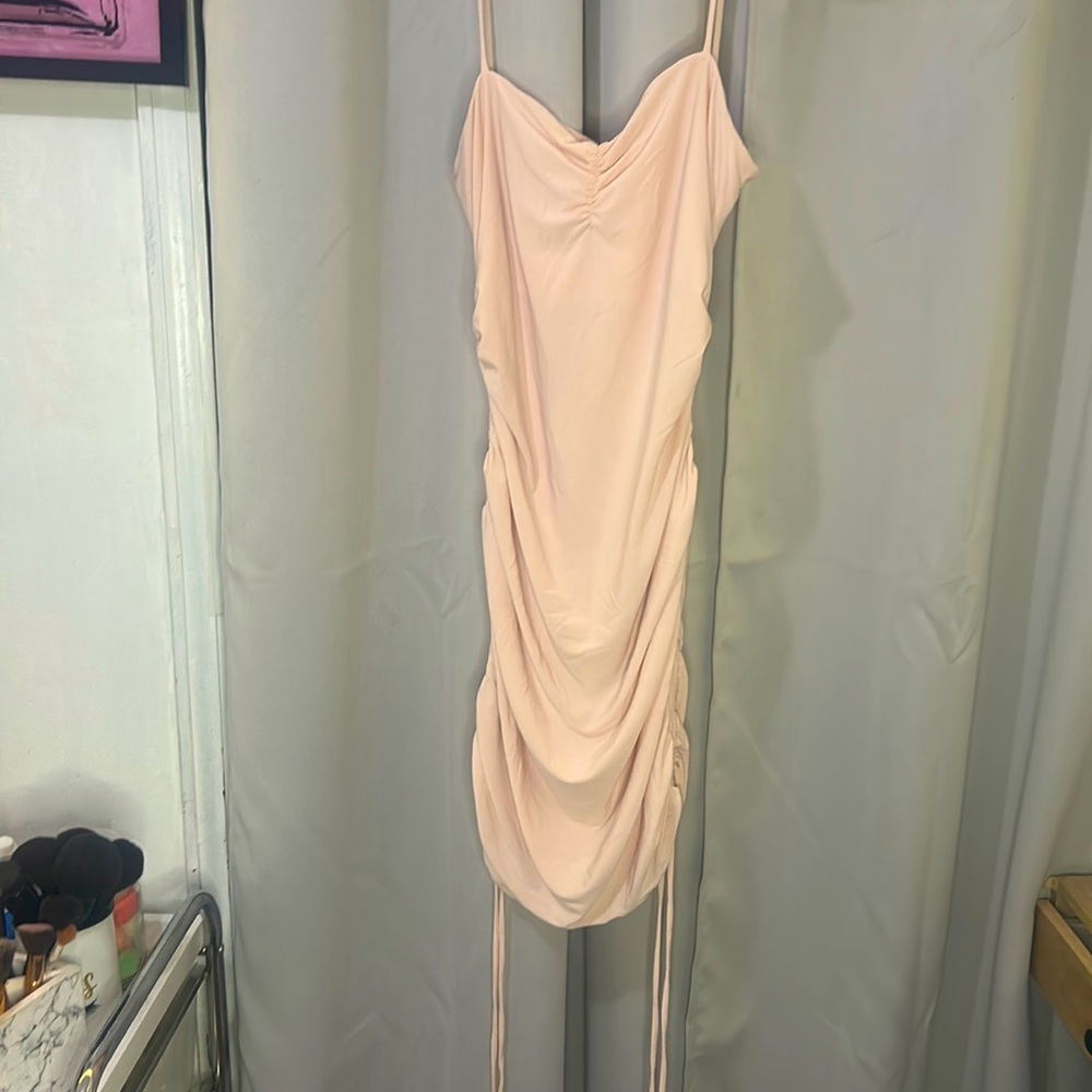 Mini pink dress adjusts to your body shape and has layers when worn.